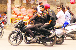 Not caring for traffic rules, three commandos of the Punjab Police travel on a motorcycle in Bathinda on Monday.