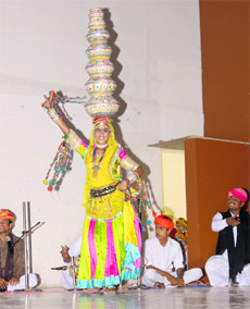 A performer exhibits the Bhawai dance by balancing pitchers on her head at Guru Kashi University on Monday. 