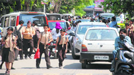 << Other commuters are the worst sufferers near Manav Mangal School in Sector 11.