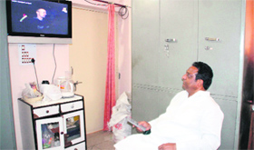 BJP mayoral candidate Vinod Chamoli watches TV at his residence.