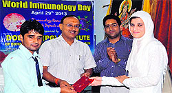 A student being honoured at a function held on the occasion of World Immunology Day at Dolphin Institute in Dehradun on Monday