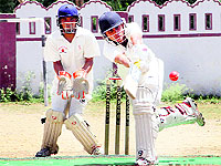 A batsman plays a shot in a match in the 61st Dehradun District Cricket League played at Survey Stadium in Dehradun on Monday