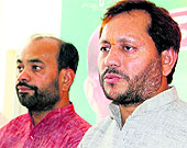 Uttarakhand BJP chief Teerath Singh Rawat (right) addressing a press conference in Dehradun on Monday
