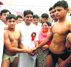 MP Deepender Hooda and Education Minister Geeta Bhukkal meet participants of a wrestling competition at Surakhpur village in Jhajjar.