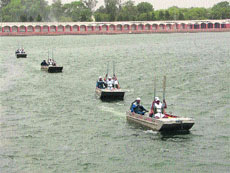 Trainees demonstrate boating at a state-level flood relief training camp that concluded on the banks of Brahmsarover. 