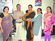 Dr Geeta Singh (centre) presents a memento to Dr Tahir Hussain in a programme at BPS Women University, Khanpur Kalan. 