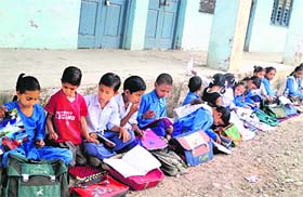Students sit in the open for lack of classrooms at Government High School in Rajouri