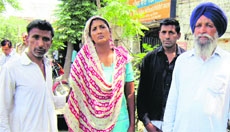 Sarbjit Kaur, wife of Kewal Singh along with their relatives in Amritsar on Tuesday.
