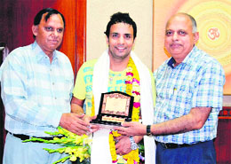 Comedian Rajiv Thakur an alumnus of DAV College, Amritsar, being felicitated by the college staff upon his visit on Tuesday. 