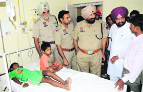 Police officials enquire about the health of the family members who suffered from food poisoning at the Civil Hospital in Bathinda on Tuesday.