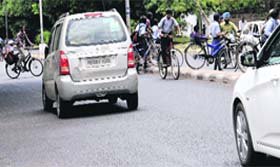 In the absence of any traffic police personnel, students cross the dividers near Government Senior Secondary School in Sector 10, Chandigarh