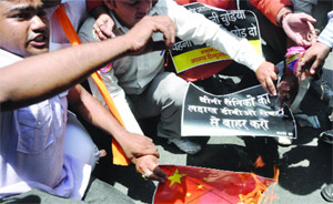  Political activists burn a Chinese flag during a protest against the alleged incursion by the Chinese troops into the Indian territory, in New Delhi on Tuesday. 