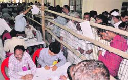 Officials counting votes at the counting centre in Roshanabad of Haridwar on Tuesday. Tribune photo: Raemshwar Gaur