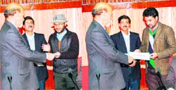 RTI activists Mohinder Singh (left) and Manjur Mohammed being honoured by an official of the Himachal Institute of Public Administration. A Tribune photograph