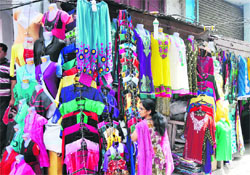 A woman looks at garments at a shop in Jammu.