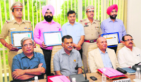 Dignitaries with police award winners at the Institute for Development and Communication in Chandigarh on Tuesday