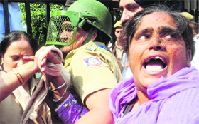 A woman protester outside the Karkardooma Court in Delhi