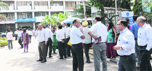 Employees stand outside the SBI building in Sector 17, Chandigarh, following the tremors on Wednesday.