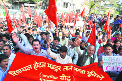 Labour and trade union activists from Leftist parties shout anti-government slogans as they march during a May Day rally in Shimla on Wednesday.