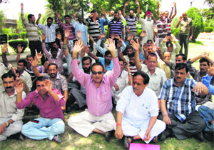 Members of the National Mazdoor Conference protest during the May day rally in Jammu on Wednesday. 