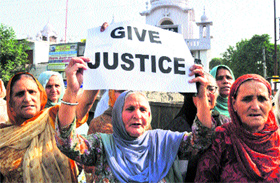 Sikhs hold a protest against the decision of a Delhi court to acquit Congress leader Sajjan Kumar in 1984 riots, in Jammu on Wednesday.