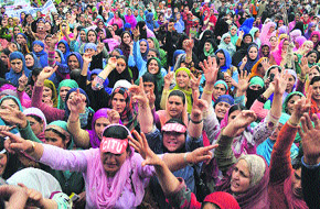 Anganwadi workers and members of other unions hold a protest to demand enhancement of their monthly honorarium and regularisation of their services in Srinagar on Wednesday.