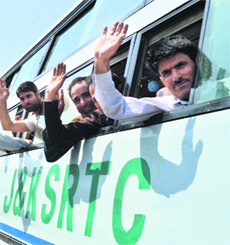 Activists of the Jammu Kashmir Liberation Front, wave before leaving to stage a protest at Jantar Mantar in New Delhi, on May 3, in Srinagar on Wednesday. 
