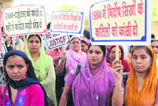 Women protest against the acquittal of Congress leader Sajjan Kumar in a riots case at the Tilak Nagar Metro station in Delhi on Wednesday. 