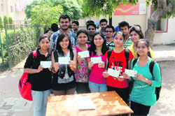 Students of Thapar University, Patiala, show the letters that they are about to post.