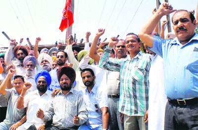 Powercom employees hold a rally on the occasion of May Day in Rajpura on Wednesday. 
