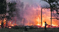 Buildings on fire during riots at Oakkan village in Myanmar on Tuesday.  Reuters