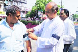 Members of the International Human Rights Organisation wear black ribbons as a mark of protest in Dehradun on Thursday.