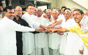 PWD Minister Randeep Singh Surjewala (third from left) with the heads of the Ror and Dalit communities following a compromise at Pabnawa village (Kaithal) on Thursday.