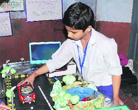 A student of a government school explains the working of his model during the Inspire exhibition in Jalandhar on Thursday