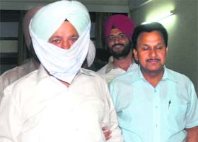 Executive Officer of the Kapurthala Improvement Trust Parkash Singh Sandhu being taken away by VB sleuths after he was arrested in Kapurthala on Thursday