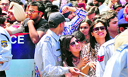 Girls stand outside the mall to catch a glimpse of the actor in Ludhiana on Thursday