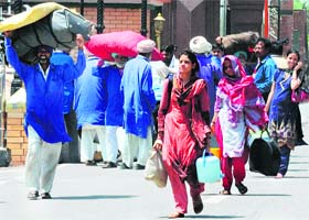 A Pakistan-based Hindu family crosses over to India through the Attari-Wagah border on Wednesday