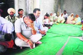 Mourners at Sarabjit Singh's house in Bhikhiwind on Thursday