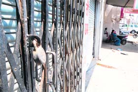 A lock at one of the shops in Tarn Tarans Bhikiwind town which observed a complete strike on Thursday