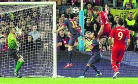 Thomas Mueller (second from right), who scored twice in the first leg of the Champions League semifinal against Barcelona, heads in the third goal for a rampant Bayern Munich on Wednesday, completing a 7-0 aggregate whitewash