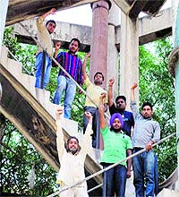 Unemployed youths protest atop a water tank in Amritsar on Thursday