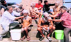 Volunteers of Sahara Jan Sewa, an NGO, give a bath to mentally challenged persons in Bathinda on Friday