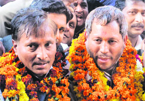 BJP state chief Teerath Singh Rawat with party workers during a brief stopover in Haridwar on Friday.