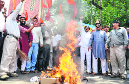 BJP workers burn the flags of Pakistan and China in Dehradun on Friday. 