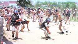 Policemen lathicharge people protesting against a demolition drive at Ashok Vihar in Gurgaon on Friday. 