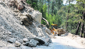 An excavator clears earthquake debris from the Doda-Bhaderwah national highway in Bhaderwah town.