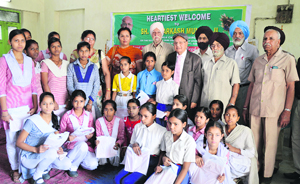 The needy students who were given uniforms by the members of the Shaheed Memorial Sewa Society in Ludhiana on Friday.