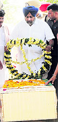 Deputy CM Sukhbir Badal lays a wreath on Sarabjits body at Bhikhiwind on Friday