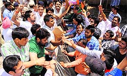 Leaders and workers of the BJP raise slogans as Congress workers try to prevent them from entering the residence of Railway Minister Pawan Kumar Bansal at Sector 28 in Chandigarh on Saturday