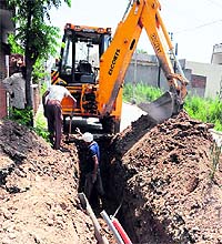 Workers of the water supply department repair the damaged water pipes